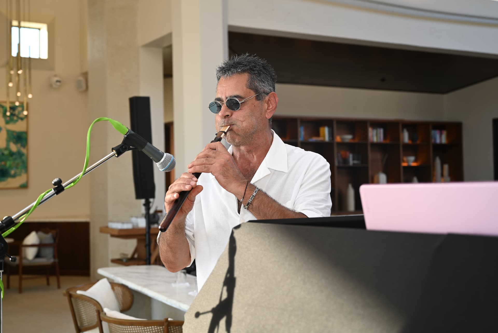 Musician playing the ney in a white shirt