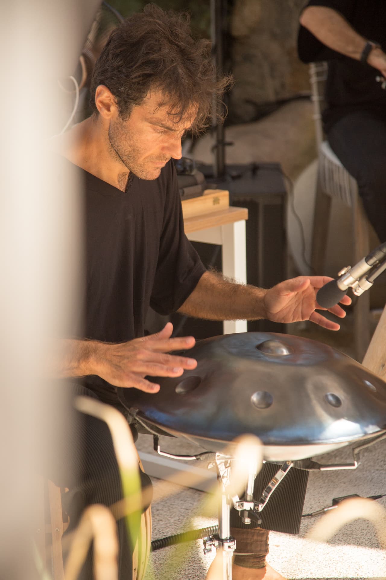 Musician in deep concentration over the handpan